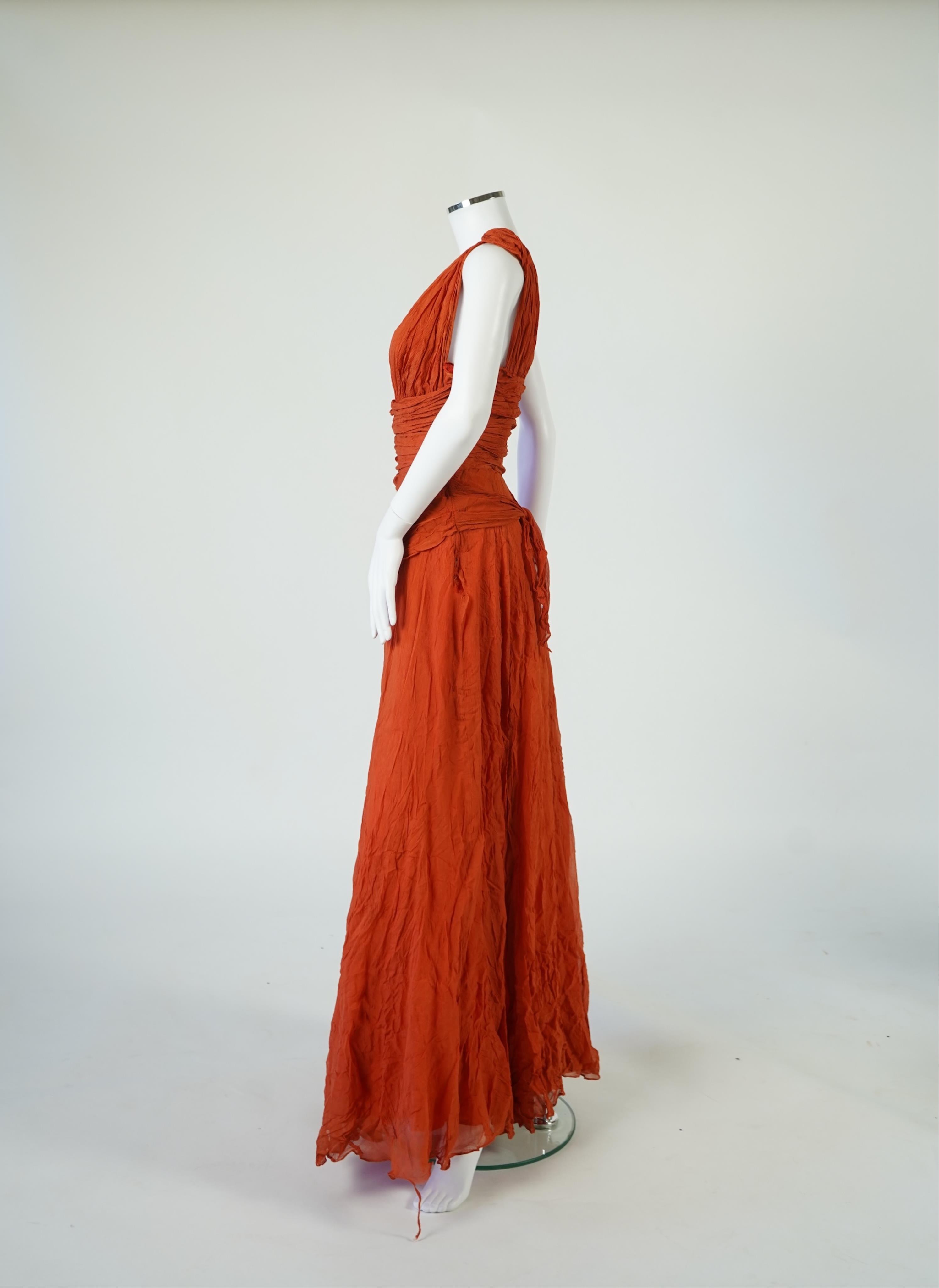 A 1940’s orange chiffon evening dress, with an orange silk taffeta lining, a pleated bodice and front apron panel tied at the back., 156 cm long. Condition - there are a few small holes in the chiffon at the back of the